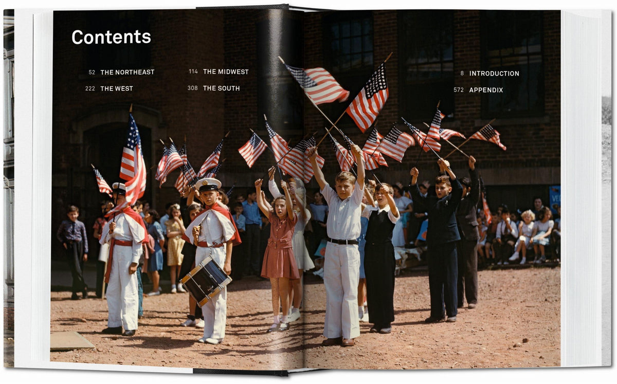 Open book showing a page with a vintage photograph of people holding American flags.